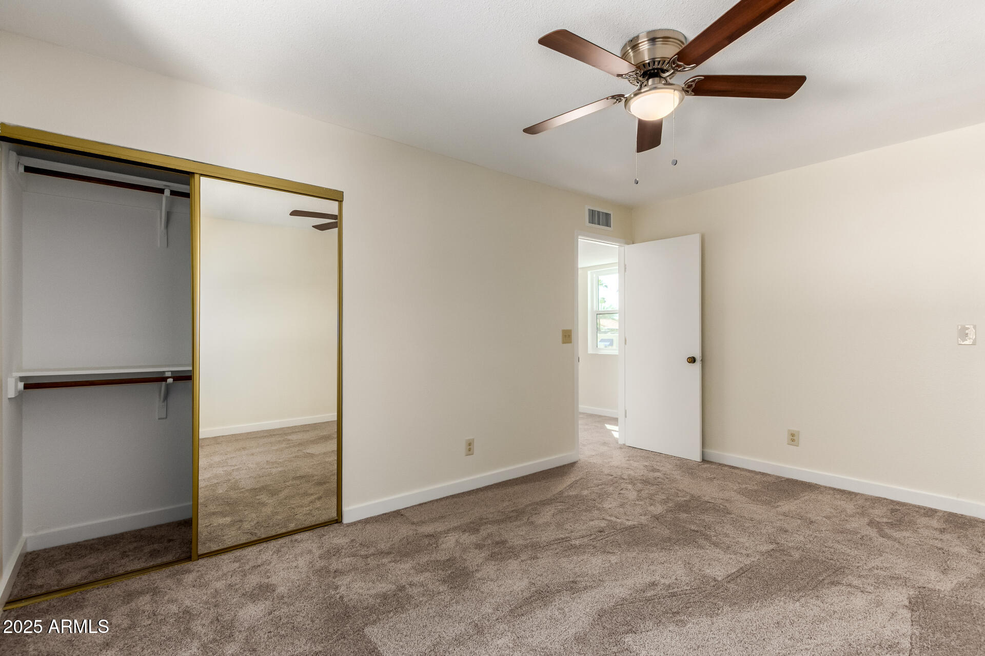 8635 South 48th Street, Unit 3 Phoenix, AZ 85044 - Photo 16 of 24 an empty room with closet and a ceiling fan