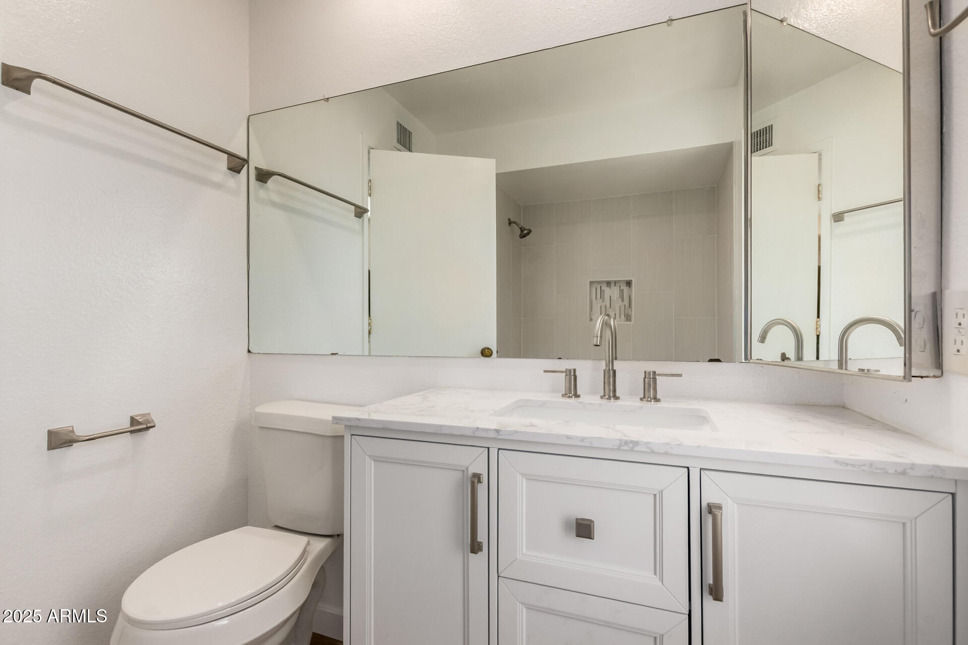 8635 South 48th Street, Unit 3 Phoenix, AZ 85044 - Photo 18 of 24 a bathroom with a sink toilet vanity and shower