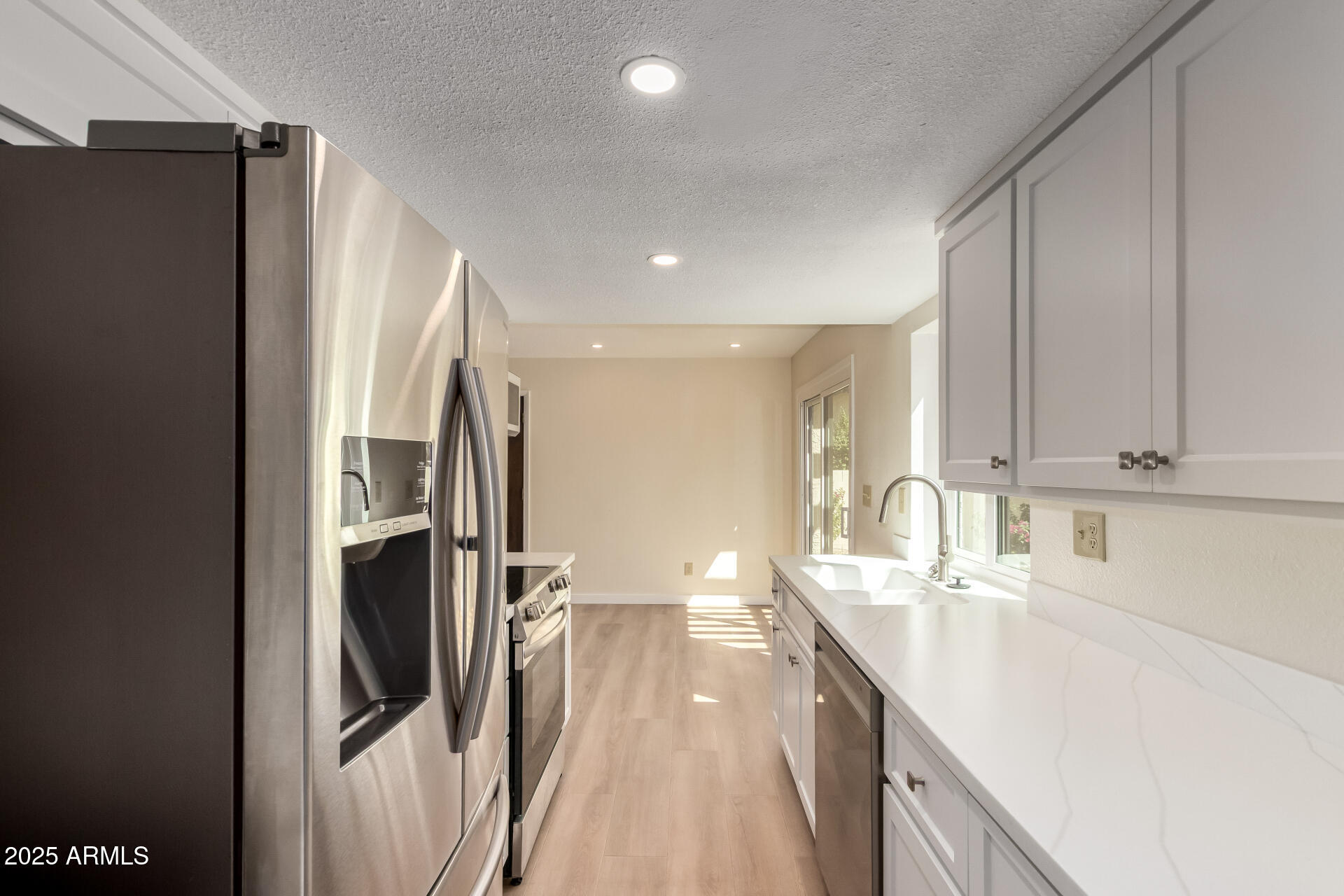 8635 South 48th Street, Unit 3 Phoenix, AZ 85044 - Photo 6 of 24 a kitchen with stainless steel appliances granite countertop a refrigerator and a sink
