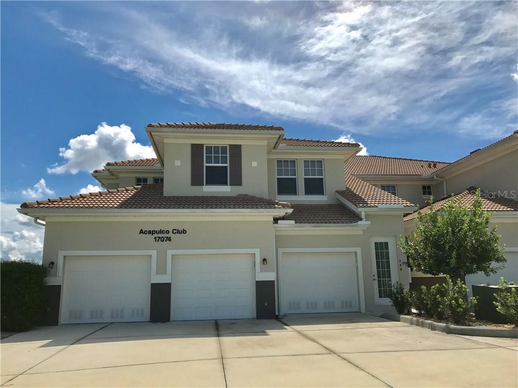 17074 Acapulco Road, Unit 122 Punta Gorda, FL 33955 - Photo 1 of 1 a front view of a house with a yard