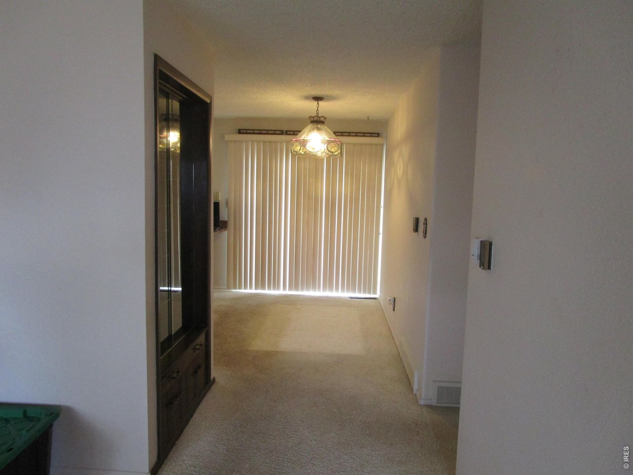 830 15th Street Burlington, CO 80807 - Photo 14 of 21 a view of a hallway with windows and chandelier fan