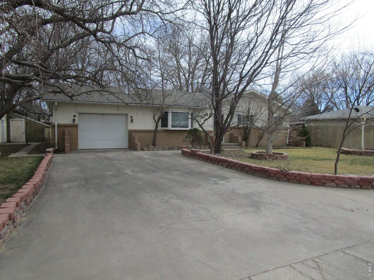 830 15th Street Burlington, CO 80807 - Photo 2 of 21 a front view of a house with a yard and garage