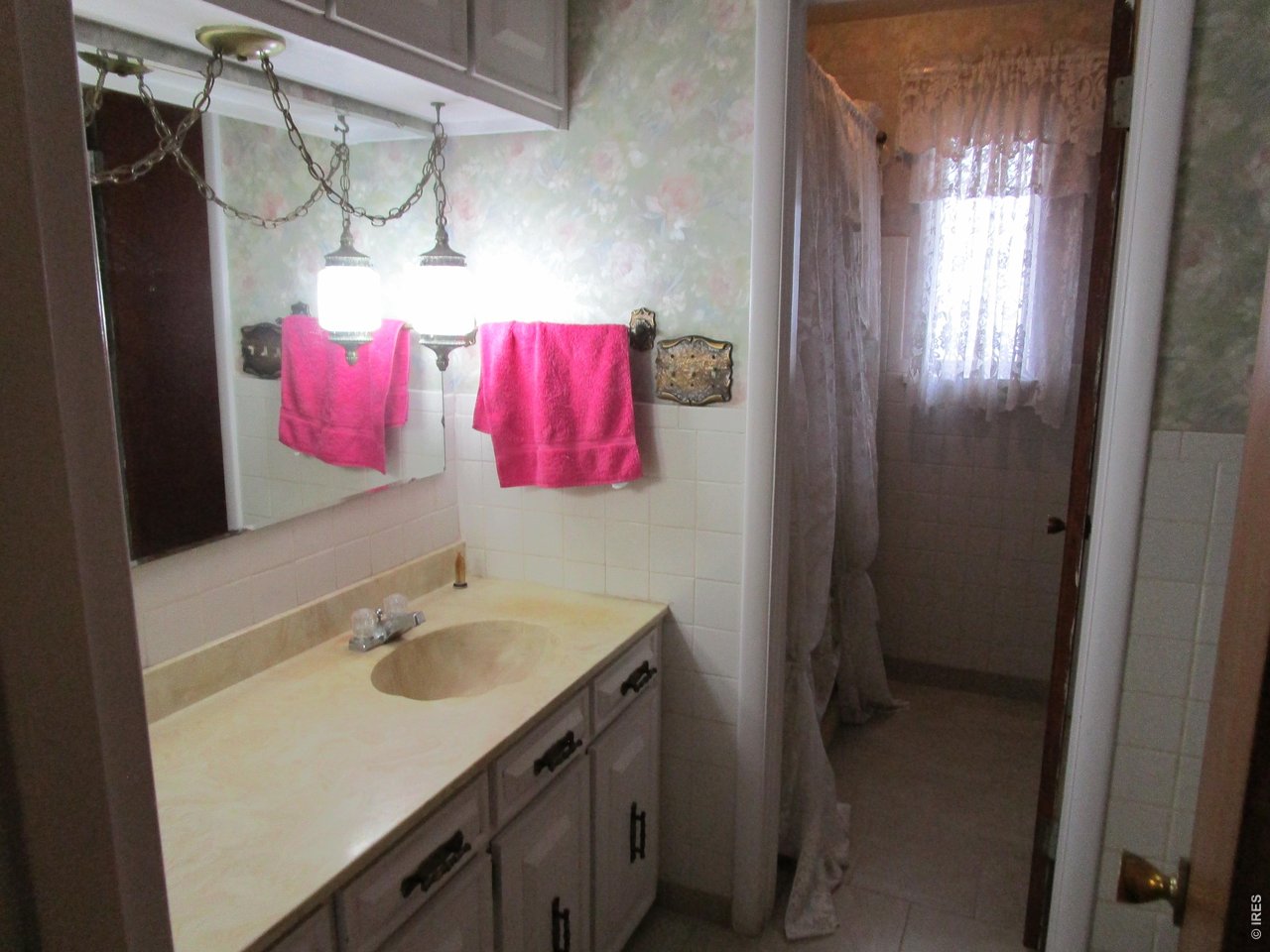 830 15th Street Burlington, CO 80807 - Photo 10 of 21 a bathroom with a sink vanity and a mirror