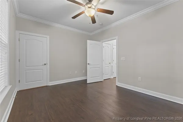 an empty room with chandelier fan
