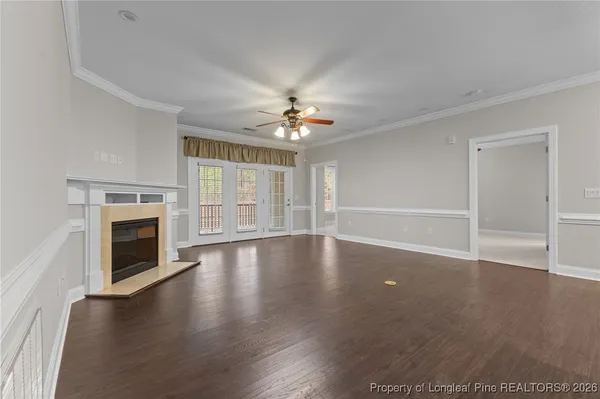 a living room with a fireplace and windows