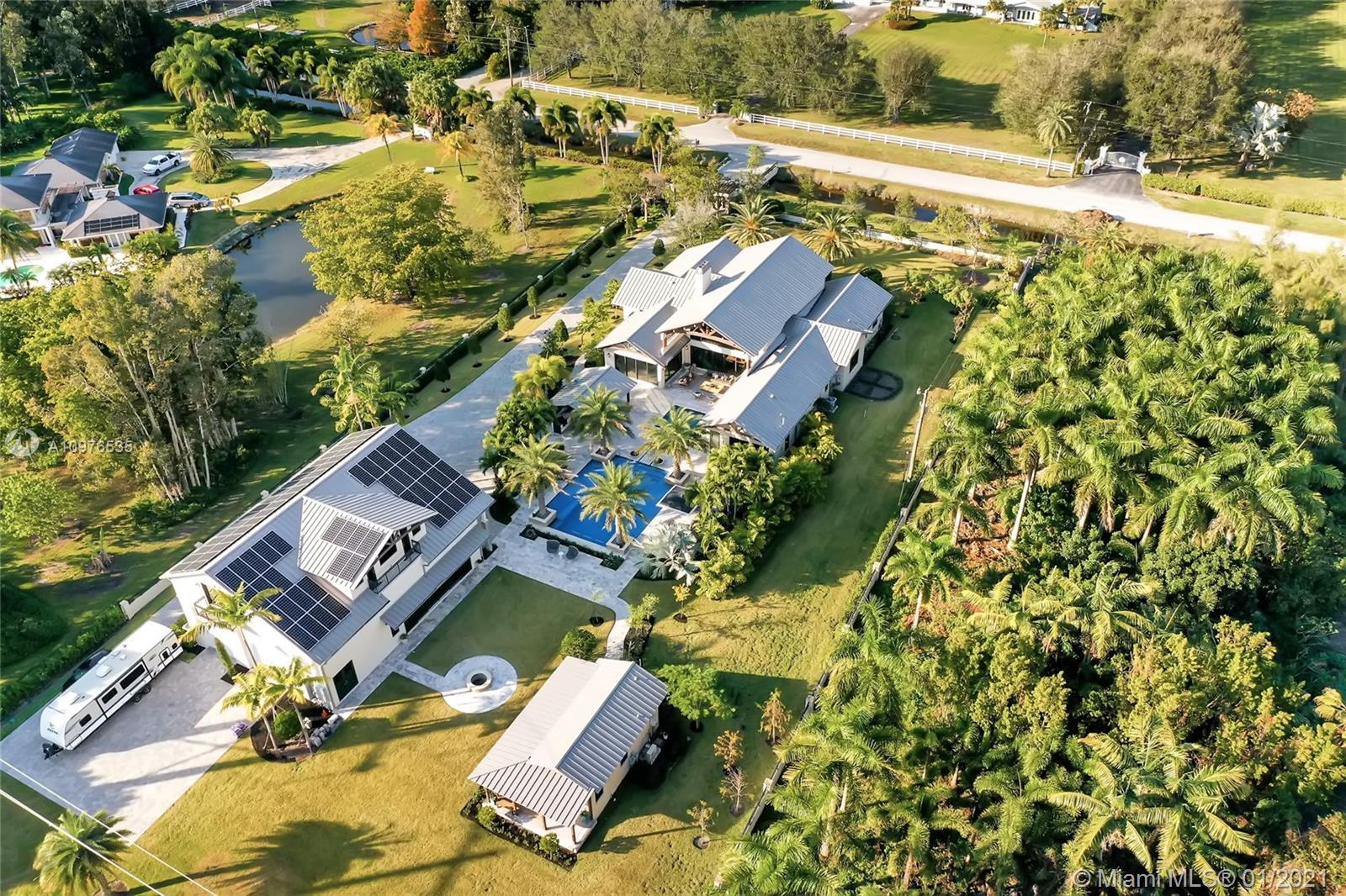 13900 Luray Road Southwest Ranches, FL 33330 - Photo 4 of 50 an aerial view of residential house with outdoor space and swimming pool