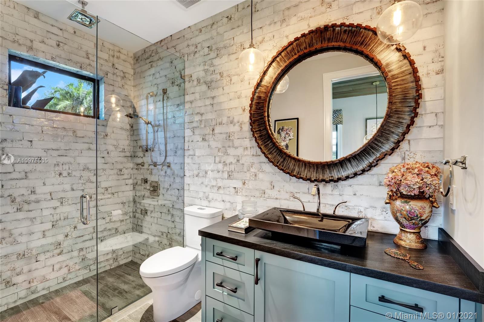 13900 Luray Road Southwest Ranches, FL 33330 - Photo 39 of 50 a bathroom with a toilet a sink and mirror