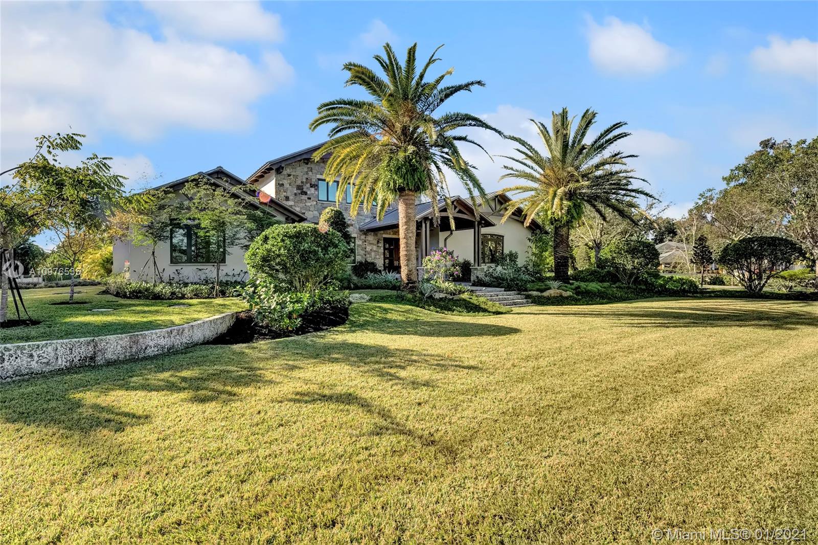 13900 Luray Road Southwest Ranches, FL 33330 - Photo 5 of 50 a view of a swimming pool with a garden and palm trees