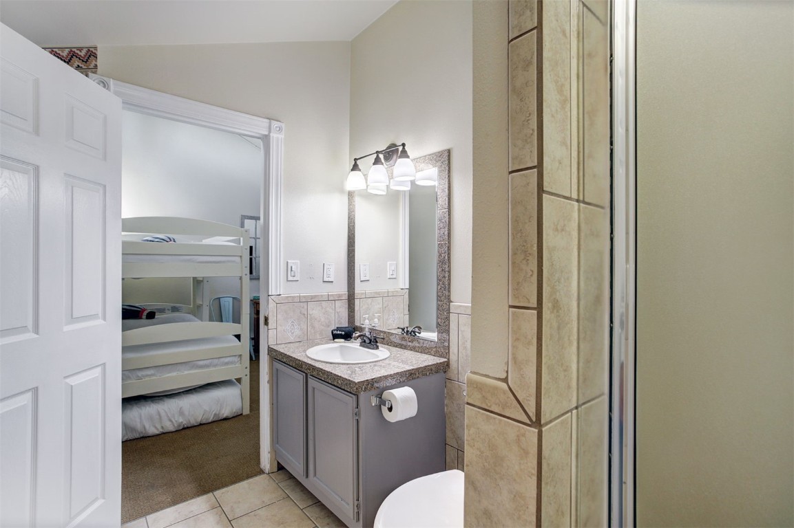 1937 Soda Ridge Road, Unit 1138 Keystone, CO 80435 - Photo 18 of 30 a bathroom with a toilet a sink and a mirror