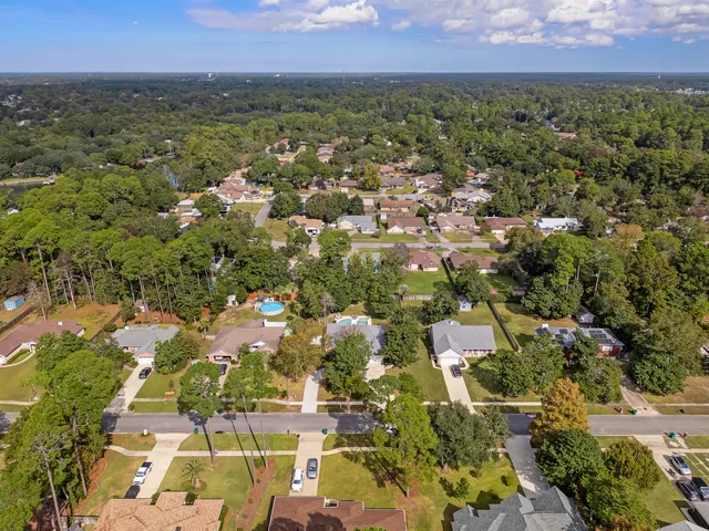 an empty room with wooden floor and a fireplace