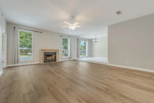 a kitchen with a sink a stove cabinets and a window