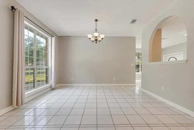 a kitchen with granite countertop a sink and white cabinets