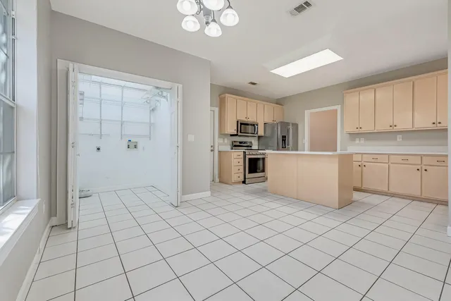 an empty room with wooden floor and ceiling fan
