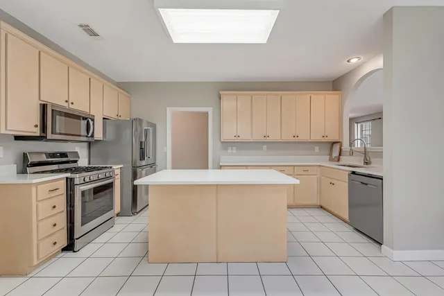 a spacious bathroom with a double vanity sink a large mirror and a shower
