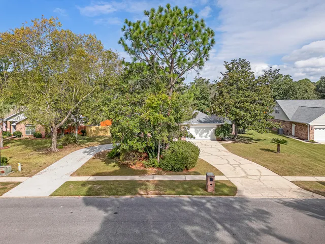 an empty room with wooden floor fireplace and windows