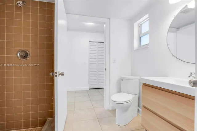a bathroom with a toilet a sink and mirror