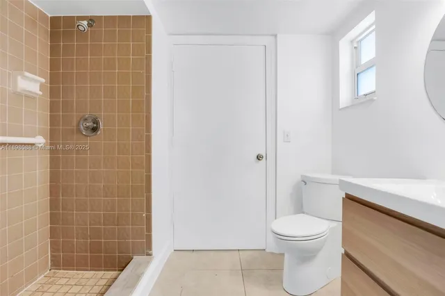 a white toilet sitting next to a bathroom sink