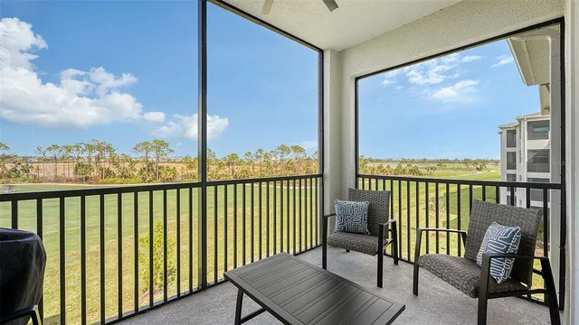 a kitchen with stainless steel appliances granite countertop a stove a microwave a sink a stove a dining table and chairs