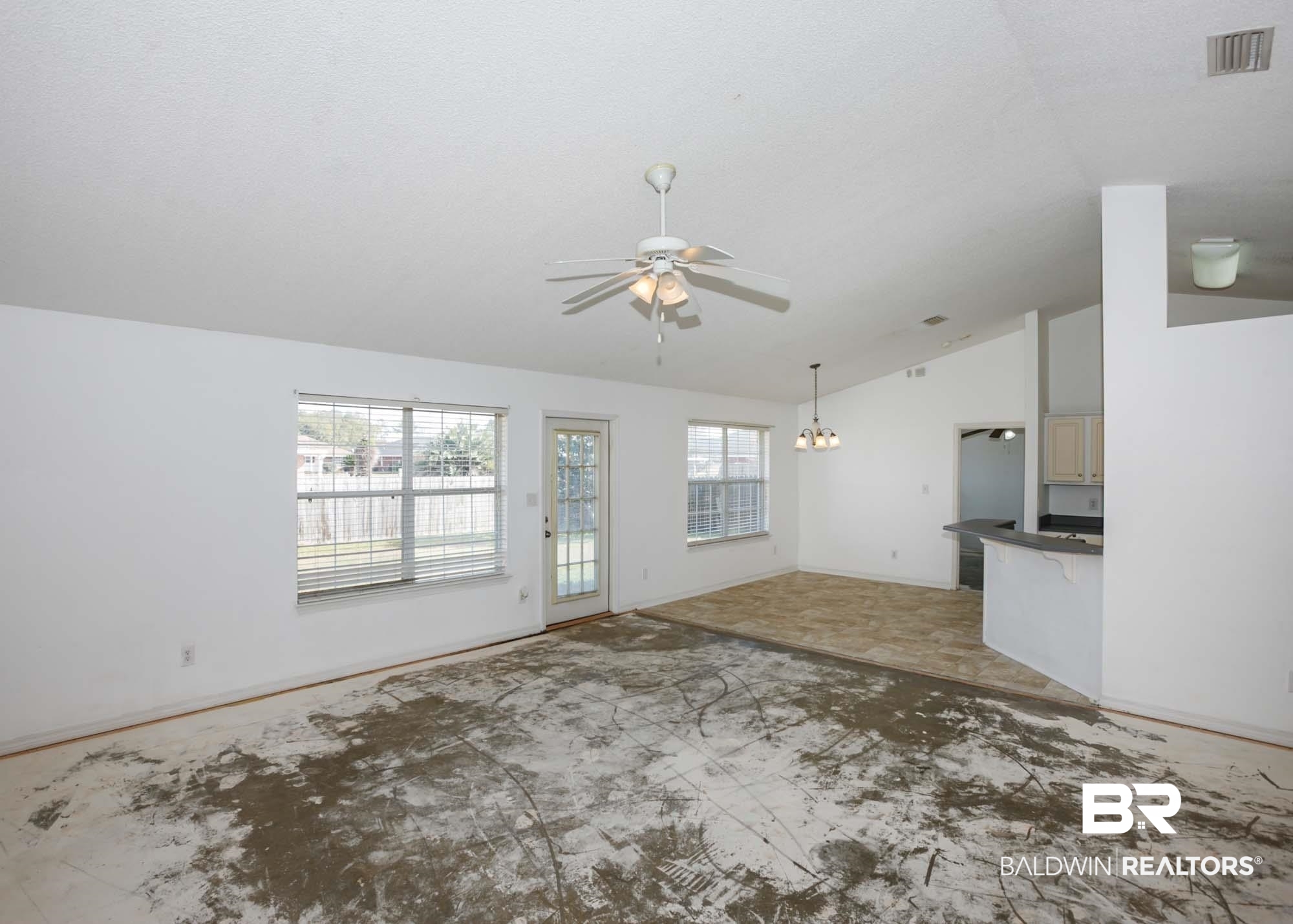 2530 Ashburn Lane Foley, AL 36535 - Photo 14 of 46 Unfurnished living room with a textured ceiling, lofted ceiling, and ceiling fan with notable chandelier