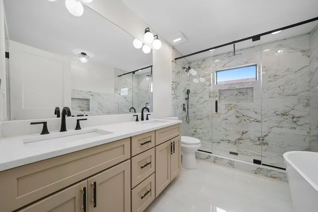 a bathroom with a double vanity sink mirror double and shower