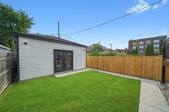 a view of a backyard with wooden fence