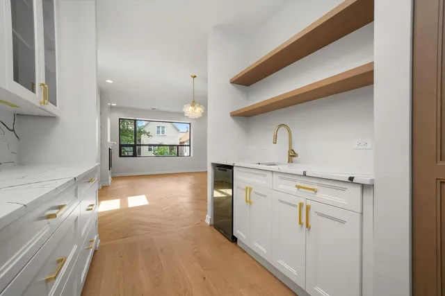 a kitchen with a refrigerator and sink