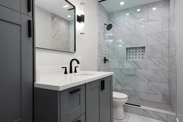 a bathroom with a sink toilet and shower