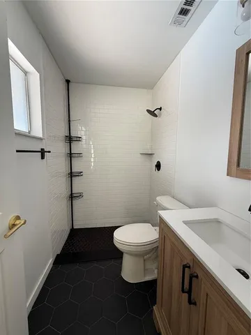 a bathroom with a sink toilet and vanity