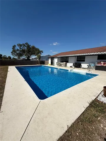 a view of swimming pool with outdoor seating