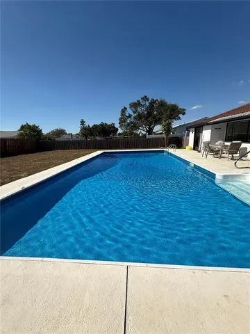 a view of a swimming pool with a patio