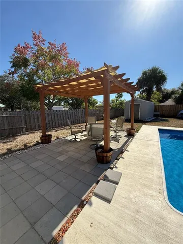 a view of a swimming pool and an outdoor seating