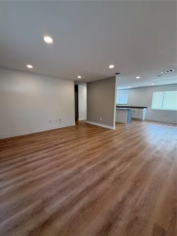 a view of a room with wooden floor