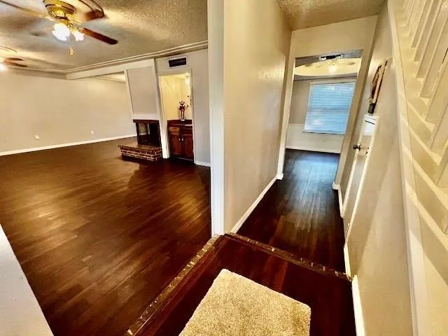 a view of a hallway with wooden floor