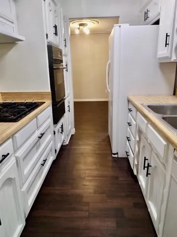 a kitchen with granite countertop a refrigerator and a stove