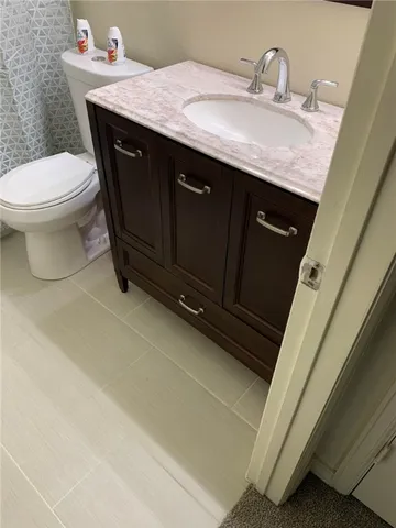 a bathroom with a sink a toilet and mirror