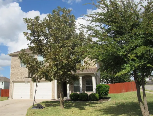 a front view of a house with a yard garage and outdoor seating