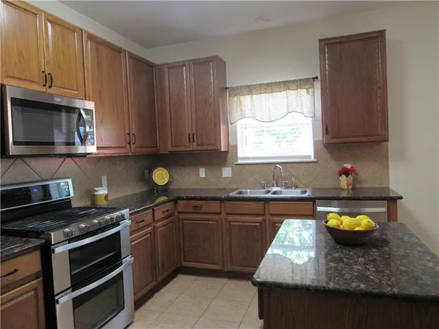 a kitchen with a stove a sink and a microwave
