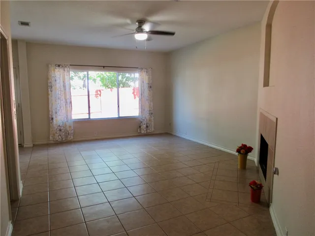 a view of empty room with windows and fan
