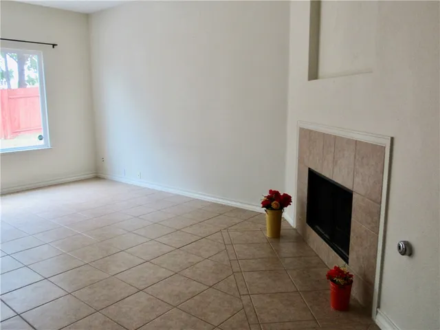 a view of a room that has a fireplace and window