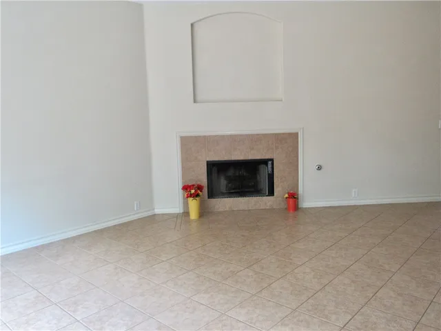 an empty room with a fireplace