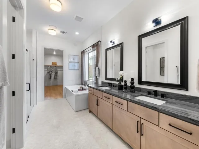 a bathroom with a double vanity sink mirror and double