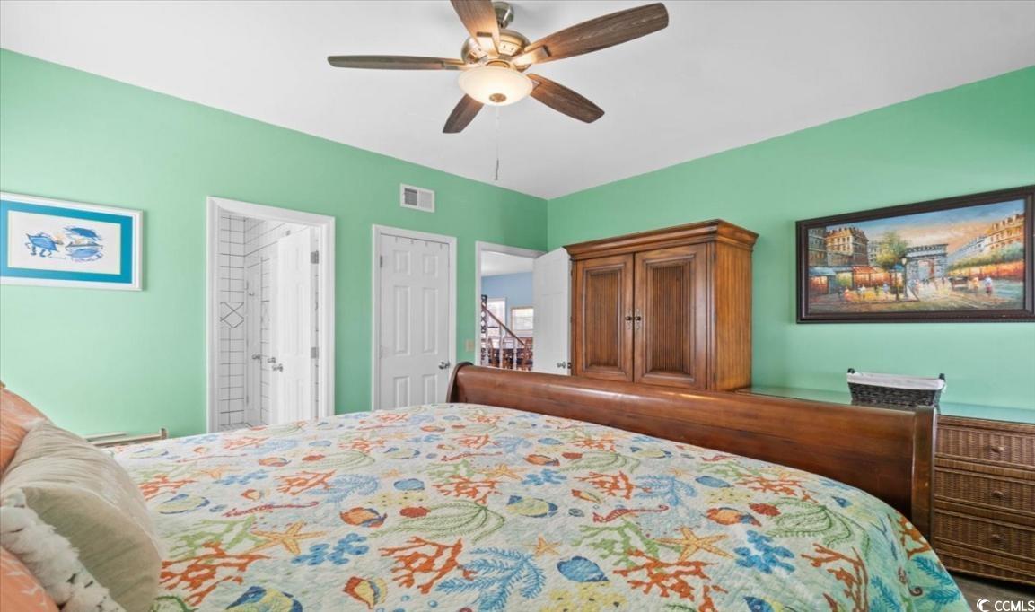 154 SandDollar Drive Holden Beach, NC 28462 - Photo 18 of 39 Bedroom with a ceiling fan and ensuite bath