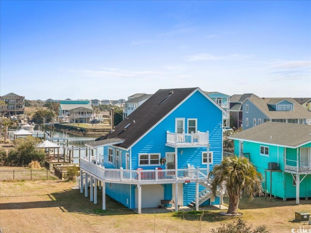 154 SandDollar Drive Holden Beach, NC 28462 - Photo 2 of 39 Back of house with a balcony, stairway, a resident