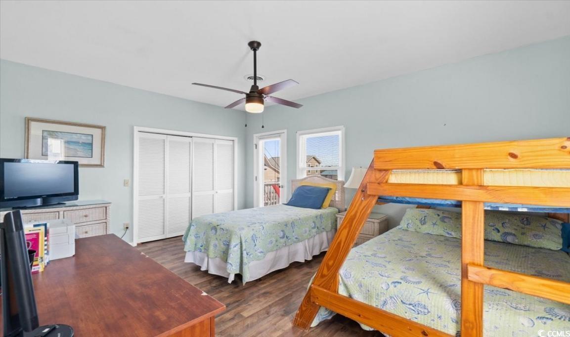 154 SandDollar Drive Holden Beach, NC 28462 - Photo 23 of 39 Bedroom with a closet, wood finished floors, and c