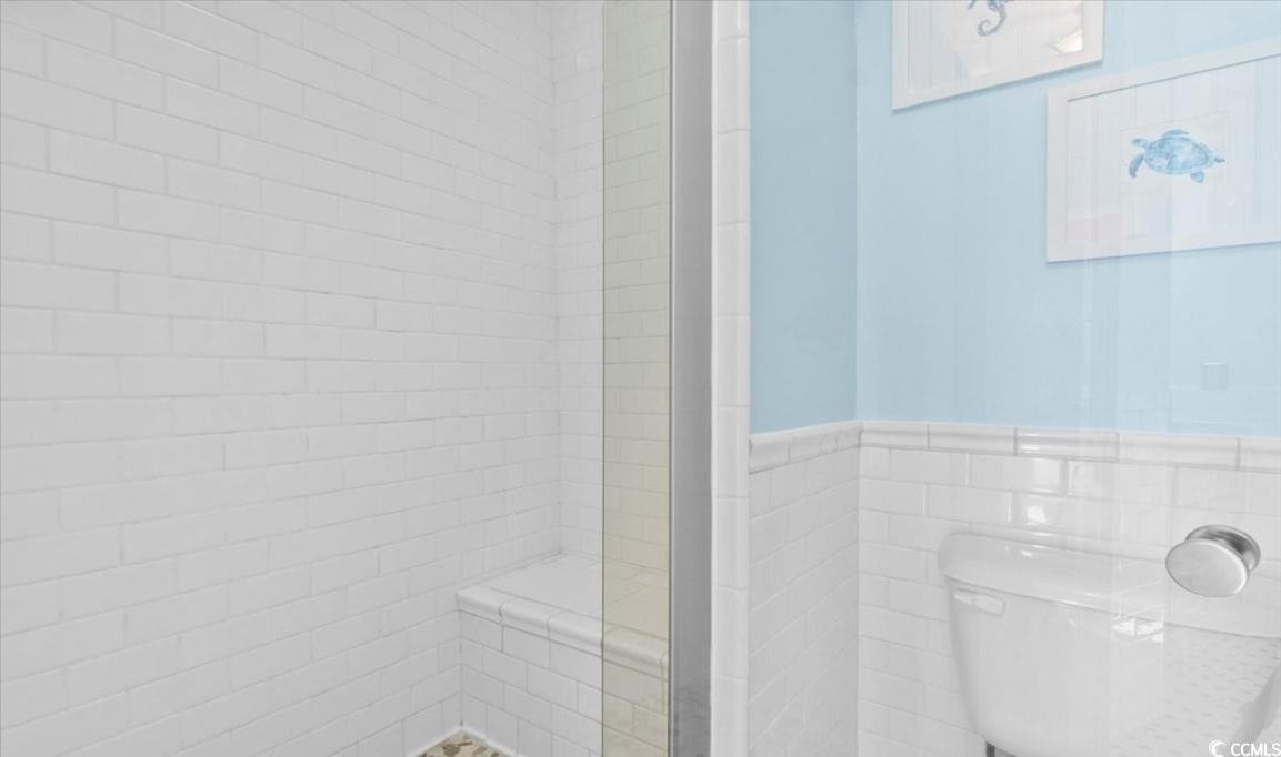 154 SandDollar Drive Holden Beach, NC 28462 - Photo 26 of 39 Full bathroom with a stall shower, tile walls, wai