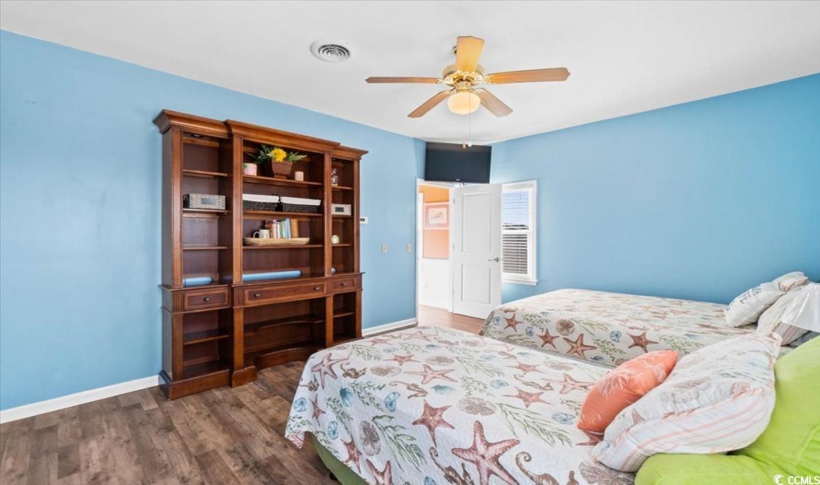 154 SandDollar Drive Holden Beach, NC 28462 - Photo 29 of 39 Bedroom with baseboards, wood finished floors, and