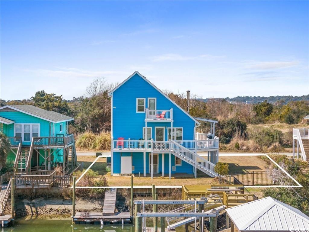 154 SandDollar Drive Holden Beach, NC 28462 - Photo 37 of 39 Rear view of house featuring stairs, a balcony, fe
