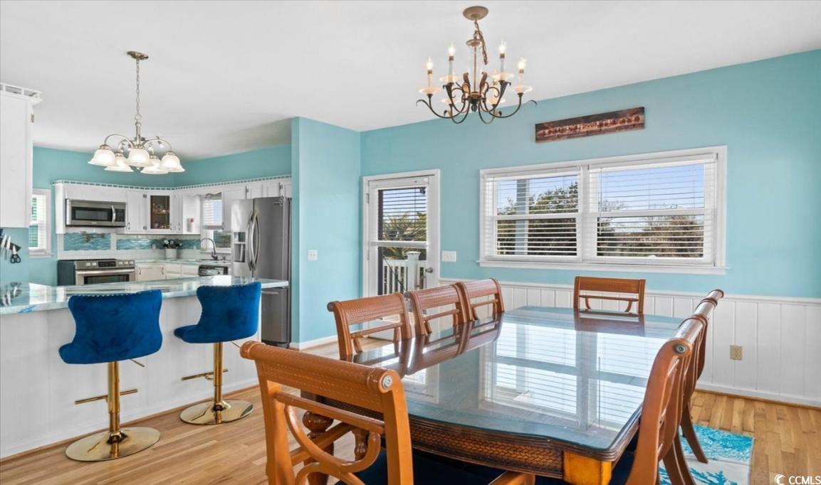 154 SandDollar Drive Holden Beach, NC 28462 - Photo 7 of 39 Dining room with a chandelier, light wood finished