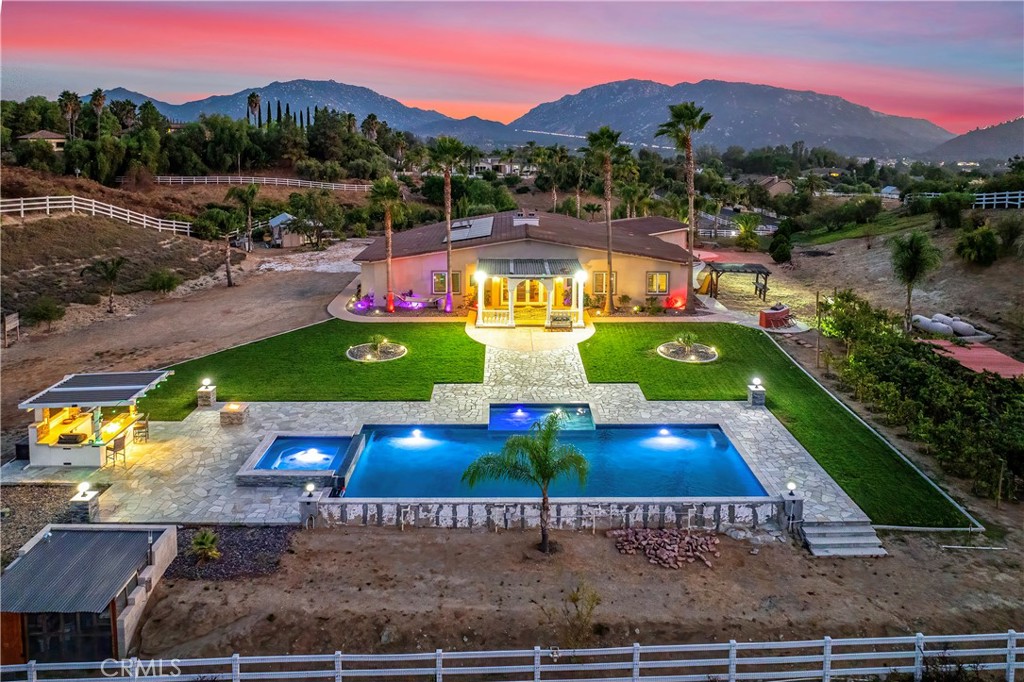 30876 Lolita Road Temecula, CA 92592 - Photo 1 of 1 a view of a swimming pool with a yard and potted plants