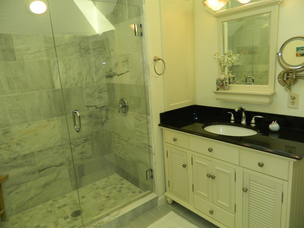 2 Copley Place Canton, MA 02021 - Photo 19 of 28 a bathroom with a shower sink and mirror